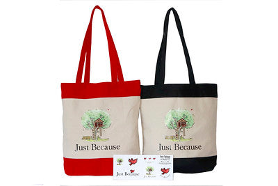 Two side by side Just Because book logo tote bags with red and black handles. 
