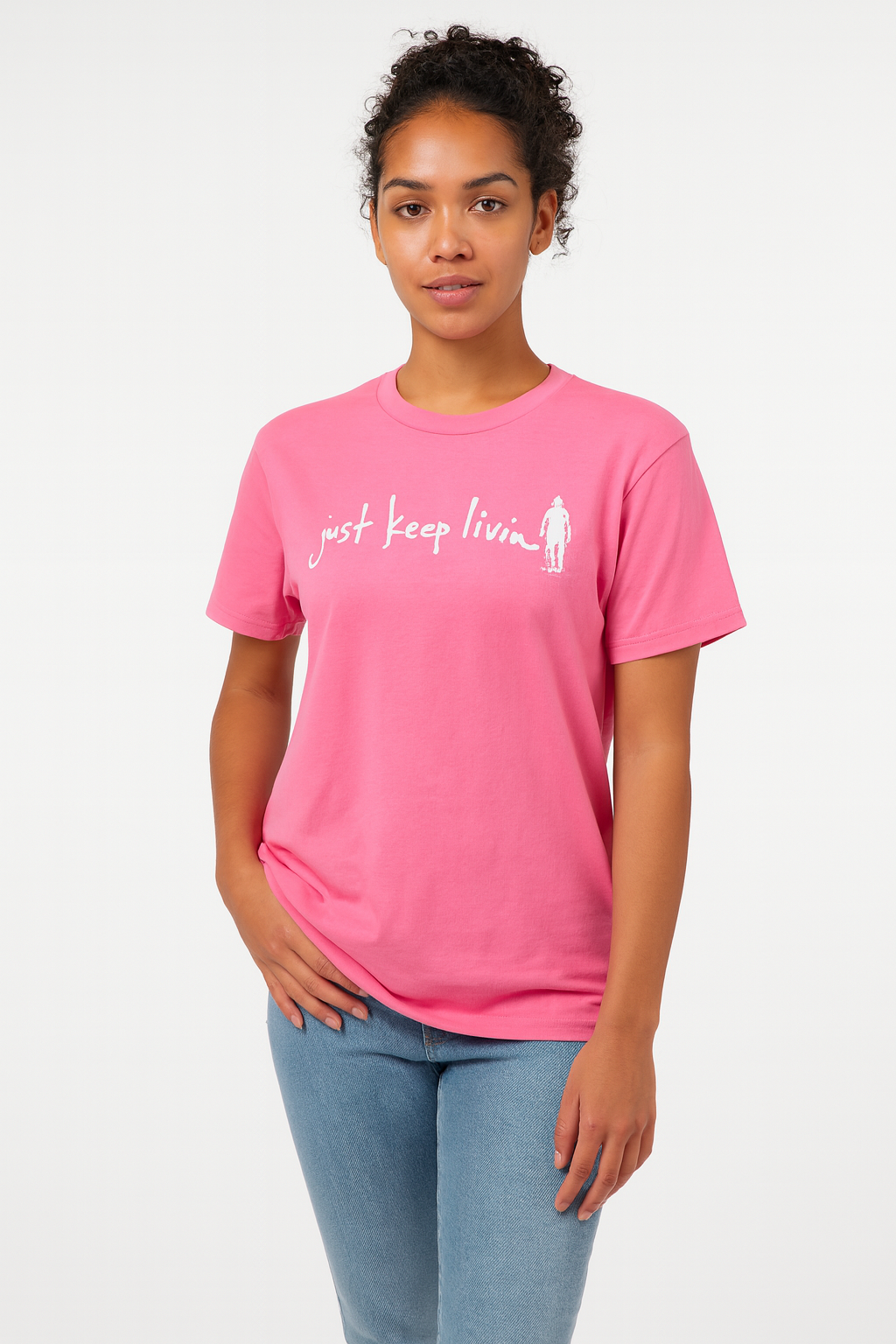 Person wearing a pink t-shirt with text and a graphic on a white background