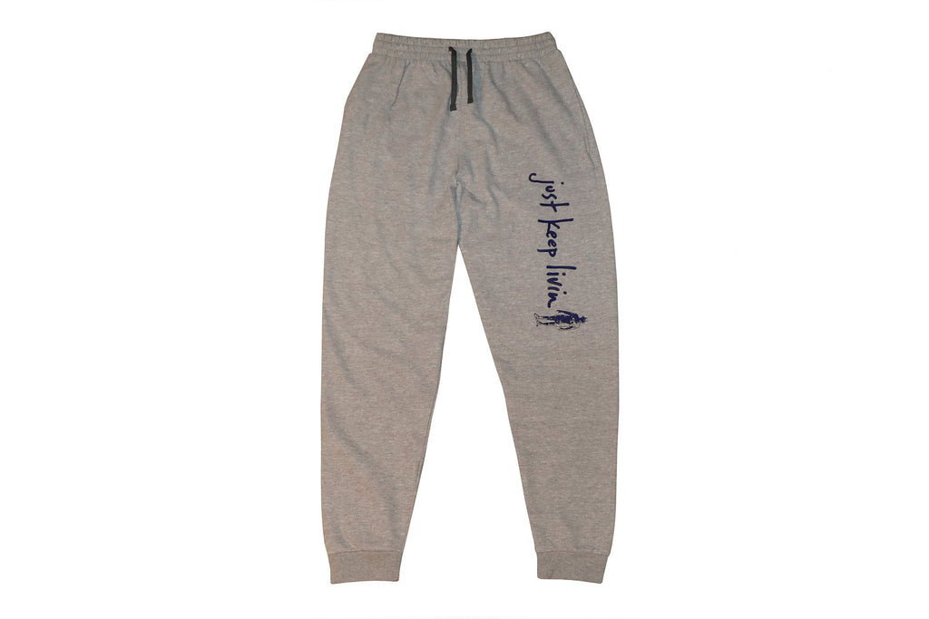 A pair of gray fleece jogger pants with a drawstring waistband and rib knit cuffs, featuring text on the left leg.