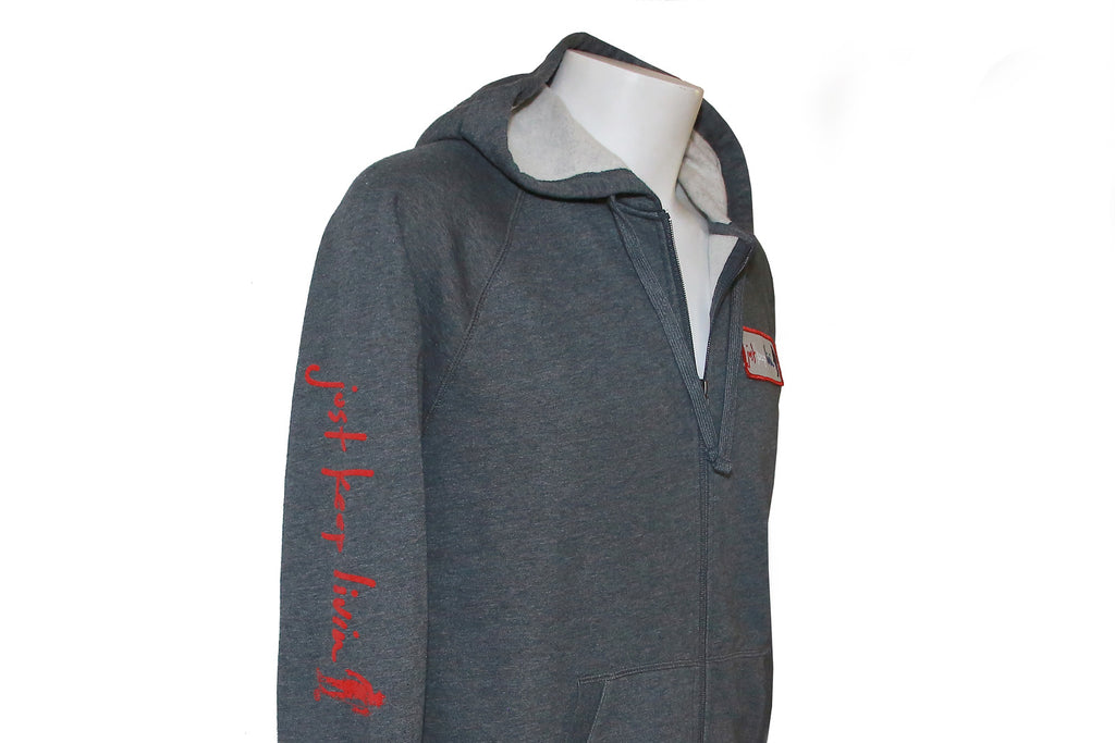 Right side view of a charcoal gray heather full zip sweatshirt with a hood, featuring a gray screenprint down the right sleeve and a gray Just Keep Living patch with red, white, and blue embroidery on the front left crest.
