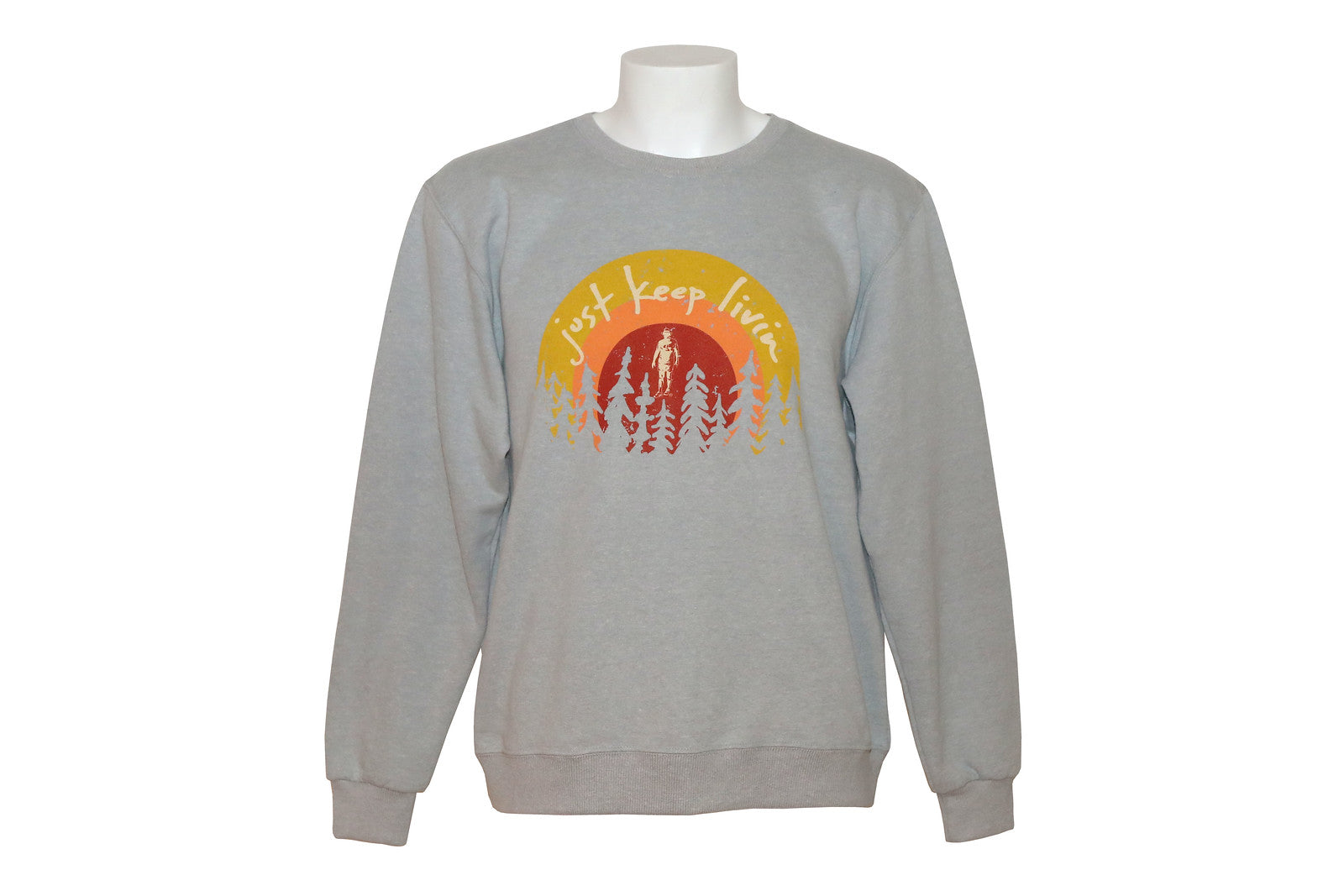 Light gray sweatshirt with Just Keep Living sunrise logo with tree silhouette background on bottom of logo. 