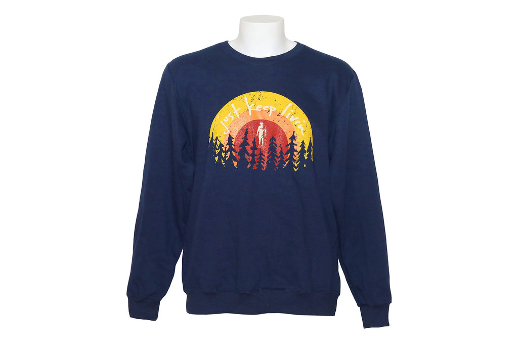 Dark blue sweatshirt with Just Keep Living sunrise logo with tree silhouette background on bottom of logo. 