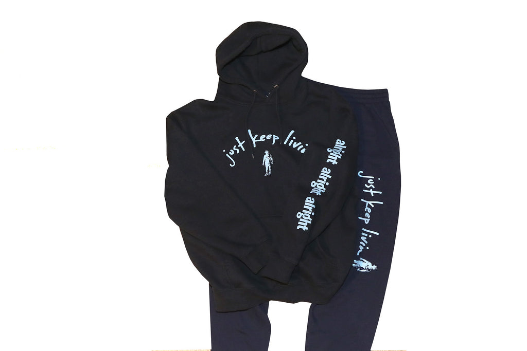Jogging sweatshirt and pant set.  just keep livin logo in light blue text on sweatshirt with alright alright alright text on left sleeve. . just keep livin text logo on left pant leg above knee. 
