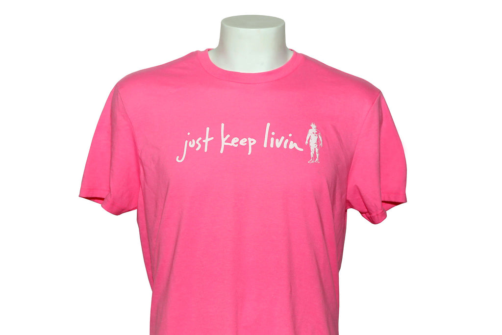A pink crew neck t-shirt on a mannequin with the text 'just keep livin' printed on the front.