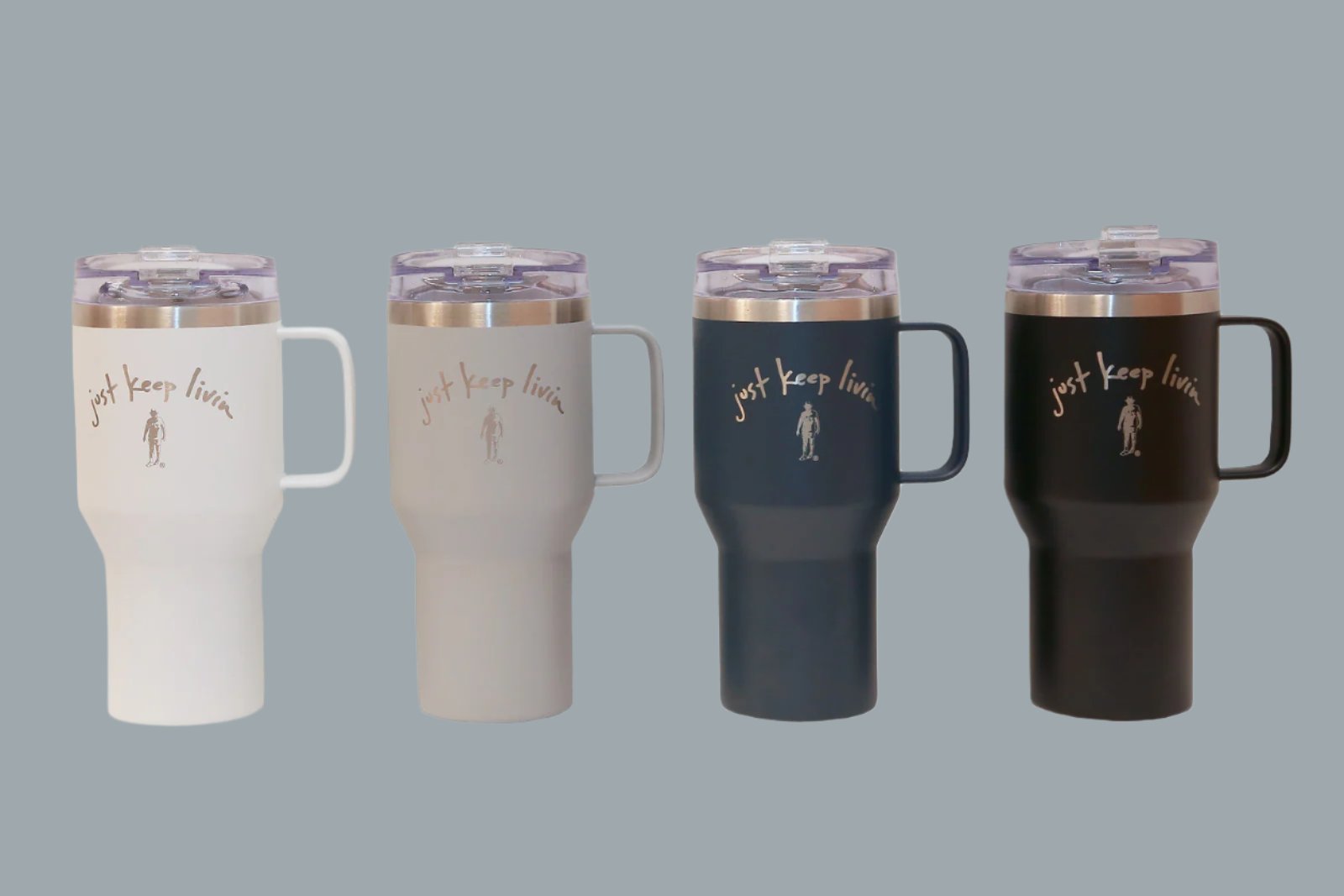 A collection of four stainless steel tumblers with double wall vacuum seal, powder coated finish, and laser engraved logo. They come in white, gray, navy, and black colors, each with a stainless handle and a plastic flip-top lid.