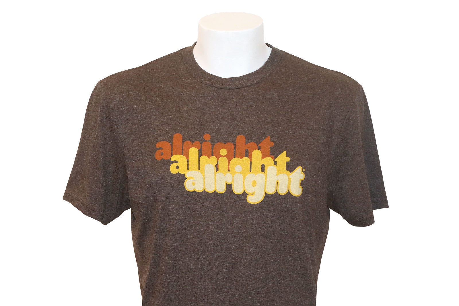 A brown t-shirt with the text 'alright alright alright' printed on the front in light brown and yellow.