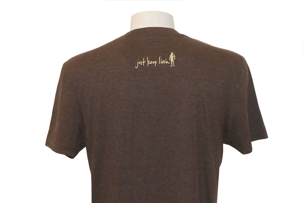 Back of brown t-shirt with just keep livin logo in tan centered in shoulder area. 