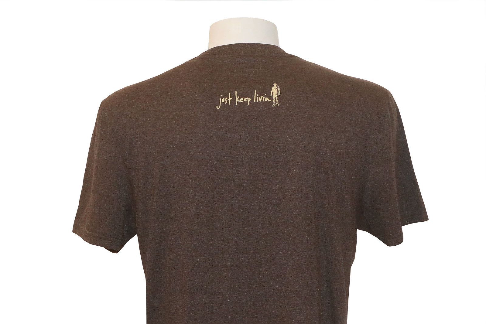 Back of brown t-shirt with just keep livin logo in tan centered in shoulder area. 